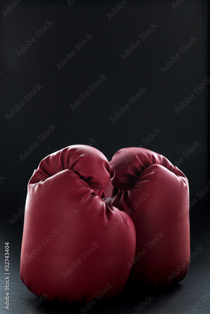 Red boxing gloves on black