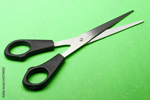 Scissors isolated on green background