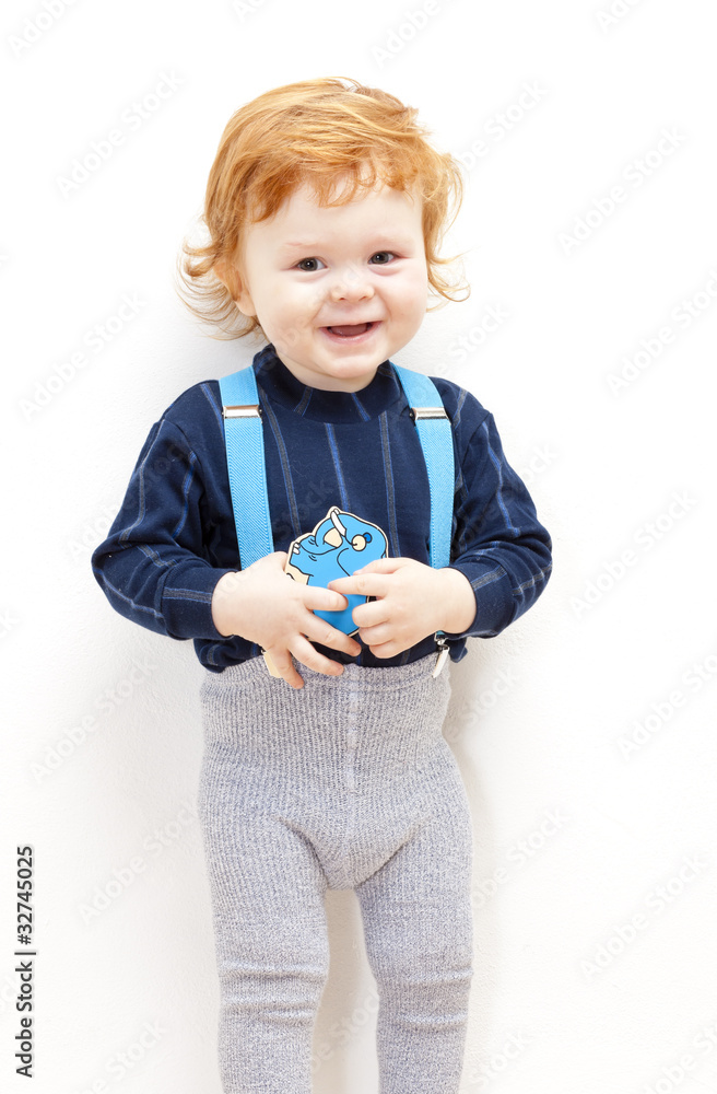 portrait of standing little boy with a toy portrait of standing little boy with a toy