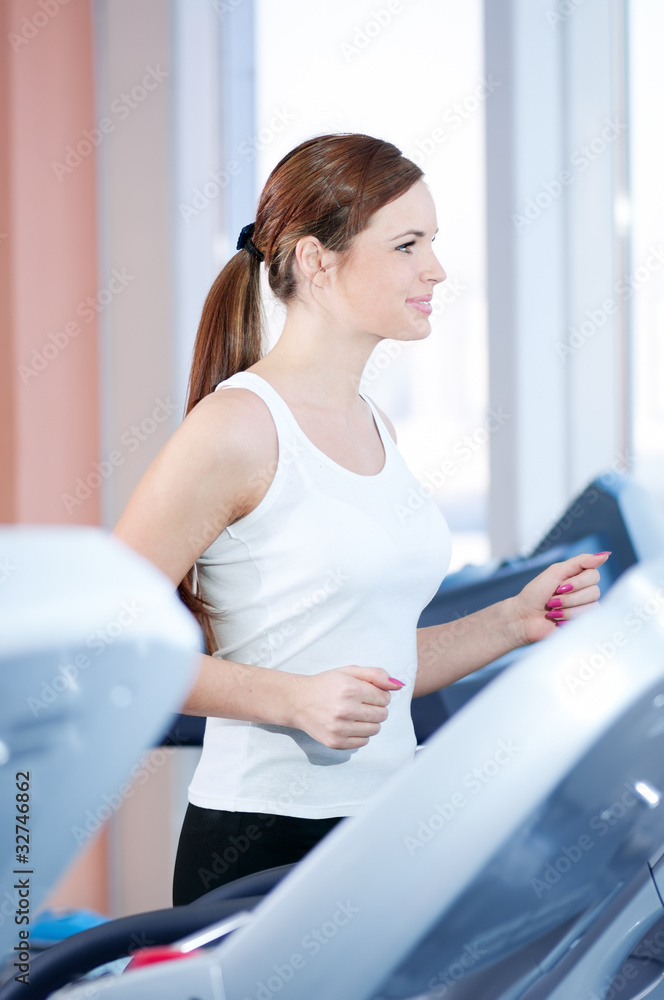 Young woman at the run at gym Young woman at the run at gym