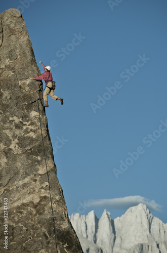 Rock climber rappelling.