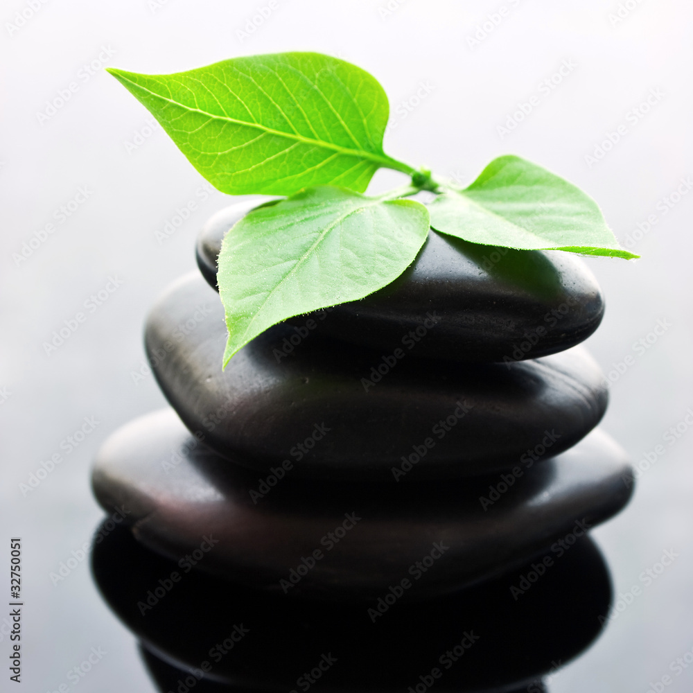 Spa stones stacked in perfect balance with leaf. Spa stones stacked in perfect balance with leaf.
