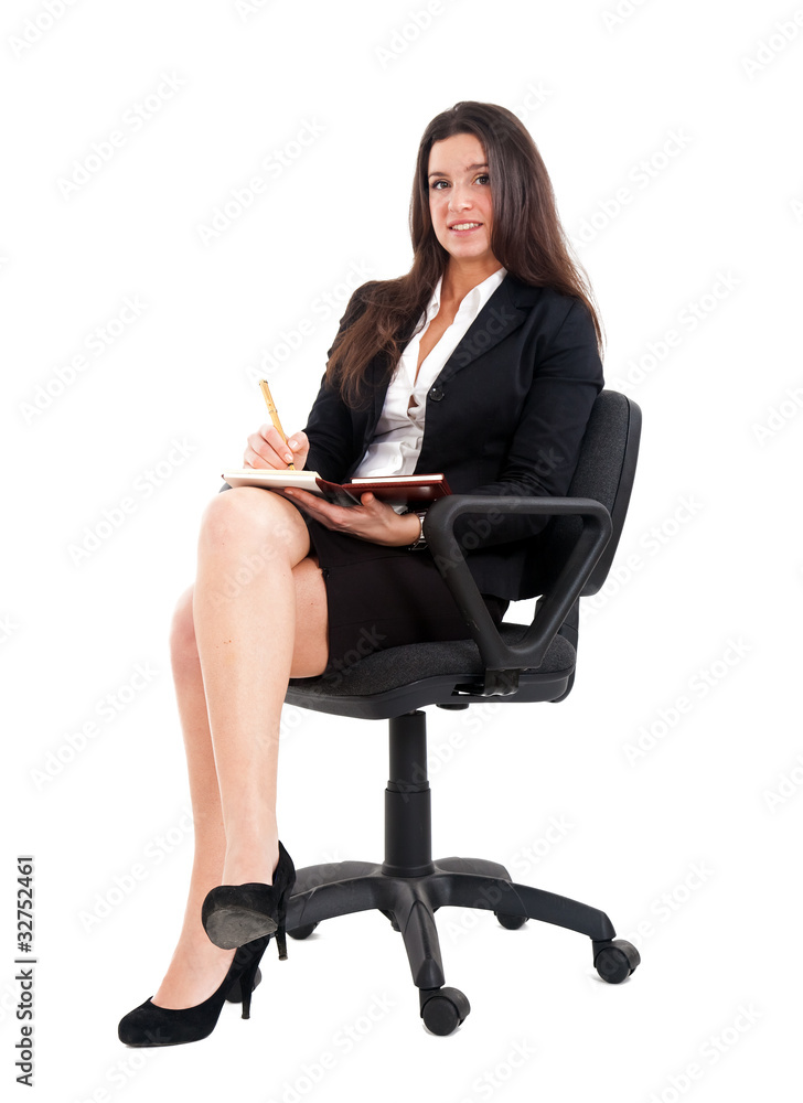 Young businesswoman sitting on a chair isolated on white