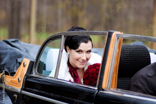 Beautiful bride in retro car