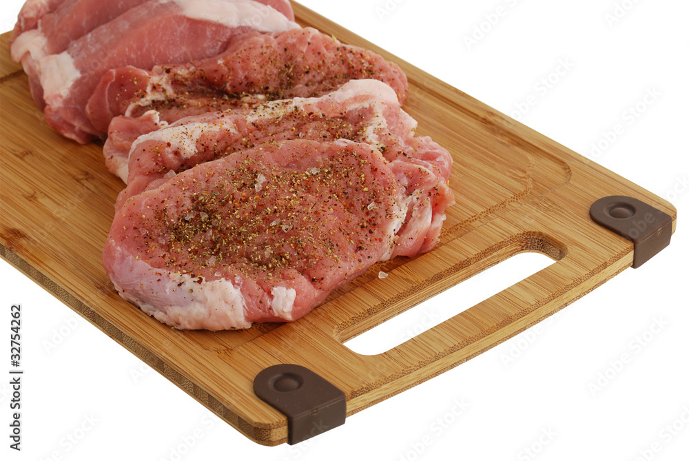 Seasoned fillet medallions on bamboo cutting board Seasoned fillet medallions on bamboo cutting board