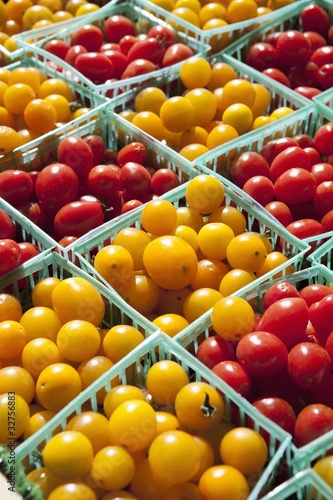 yellow and red cherry tomatoes in small baskets