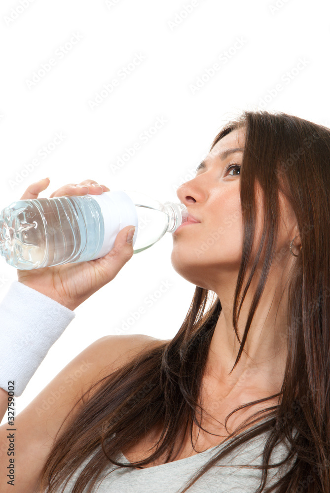 Sport Woman in sportswear drinking clear water from plastic bott Sport Woman in sportswear drinking clear water from plastic bott