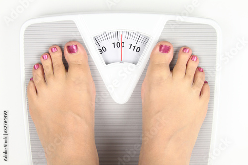 Woman’ s feet on bathroom scale