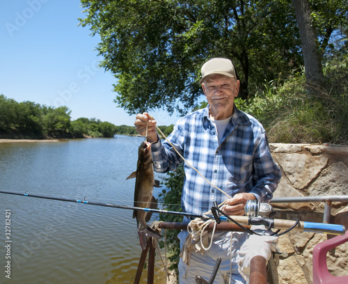 Eldery man with his catfish