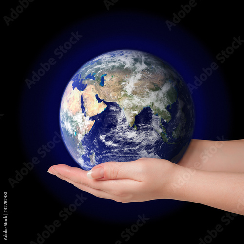 Woman holding in palms earth