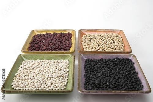 Mixed dried beans in coloreful square dishes