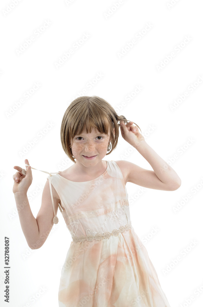 joyful child playing with hair in studio