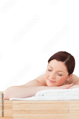 Gorgeous red-haired woman posing while relaxing in a spa centre