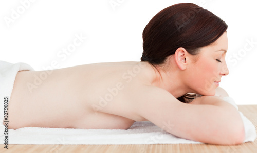Young attractive red-haired woman posing while relaxing in a spa