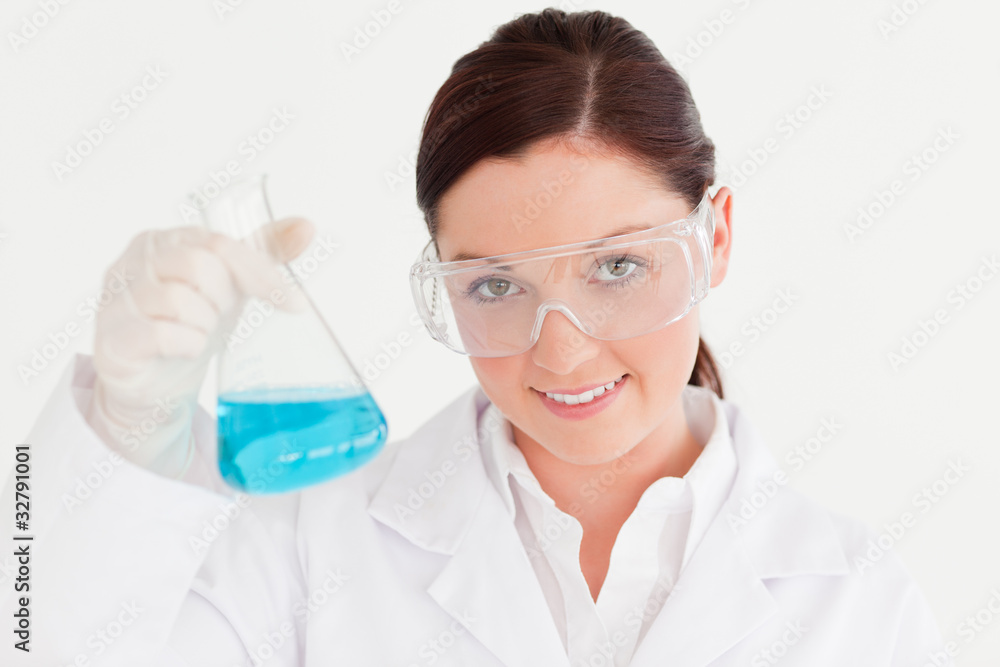 Pretty scientist looking at the camera in a laboratory