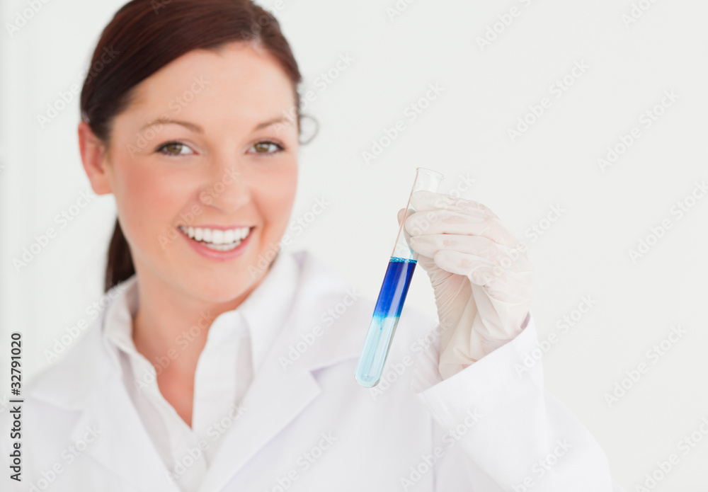 Smiling scientist looking at the camera while holding a test tu Smiling scientist looking at the camera while holding a test tu