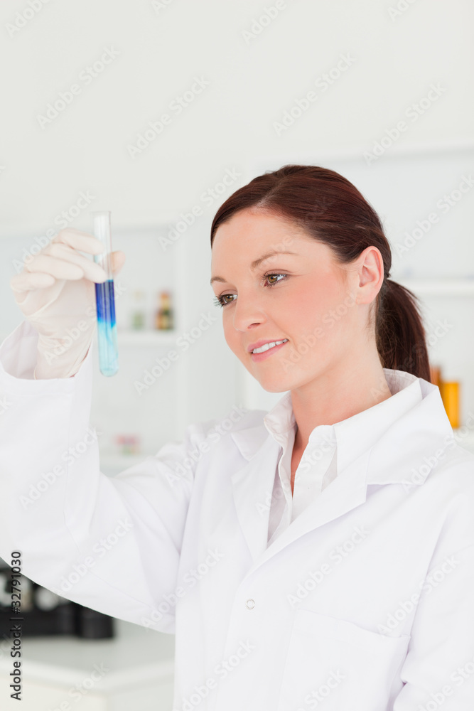 Attractive red-haired scientist looking at the camera while hold Attractive red-haired scientist looking at the camera while hold