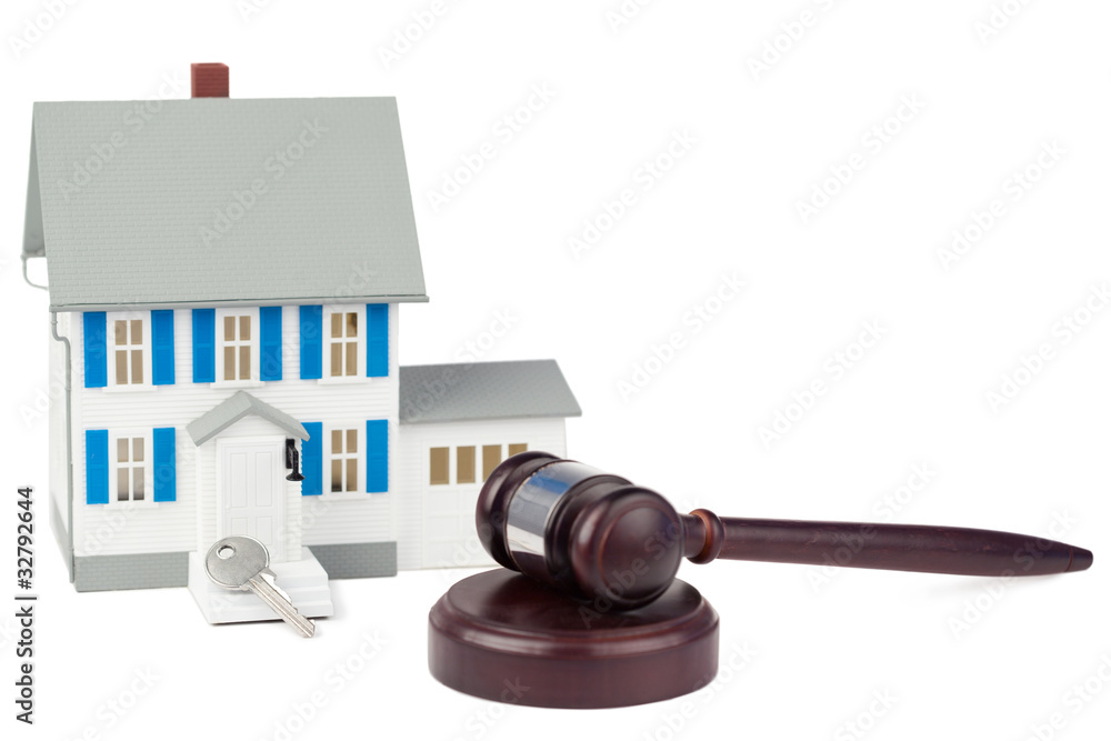 Grey toy house model with a key and a brown gave Grey toy house model with a key and a brown gave