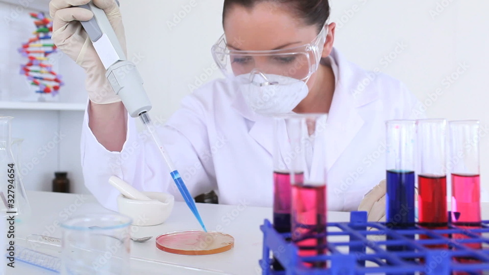 Female scientist carrying out an experiment Female scientist carrying out an experiment