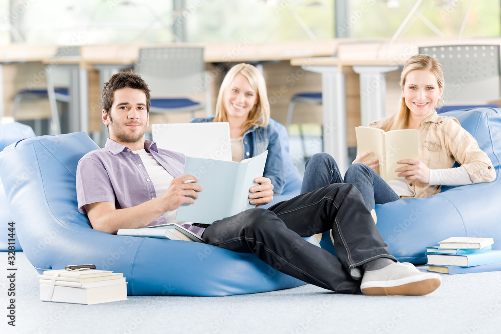 Group of high-school students with books sitting Group of high-school students with books sitting