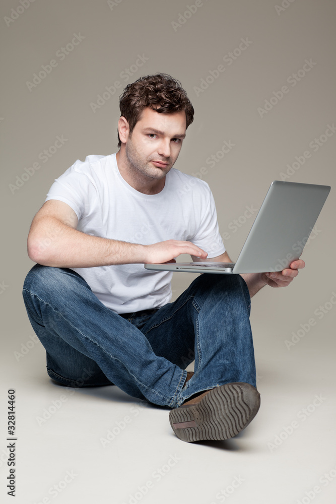 man sitting and holding laptop man sitting and holding laptop