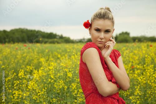 blond woman relaxing on a green meadow