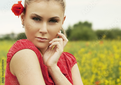 Blond woman on green meadow