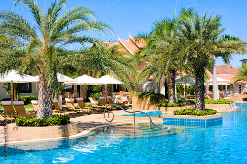 Swimming pool in luxury resort under blue sky