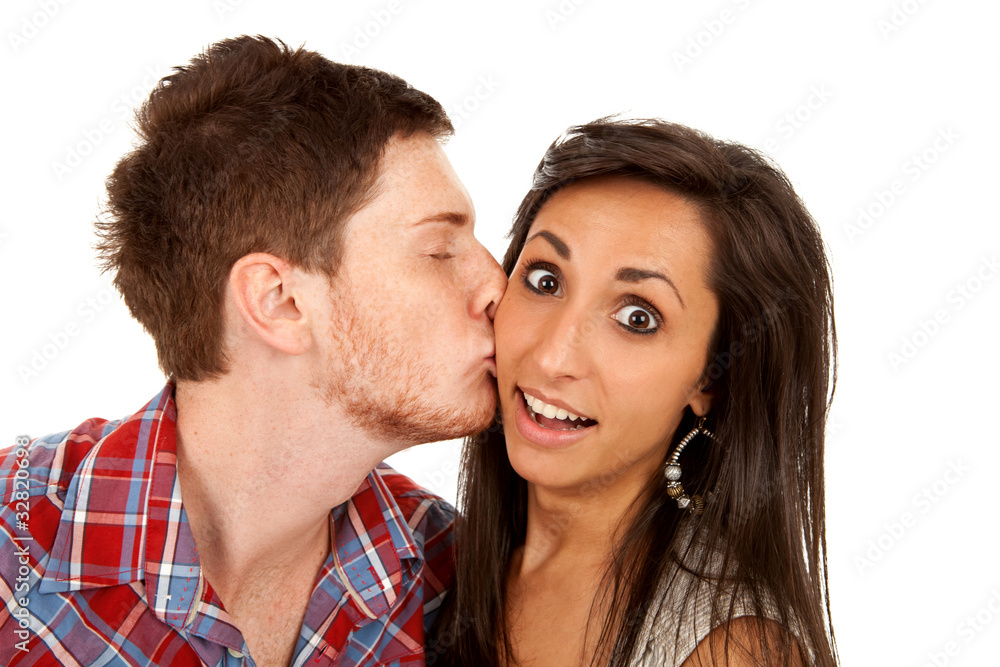 woman kisses her boyfriend on the cheek woman kisses her boyfriend on the cheek