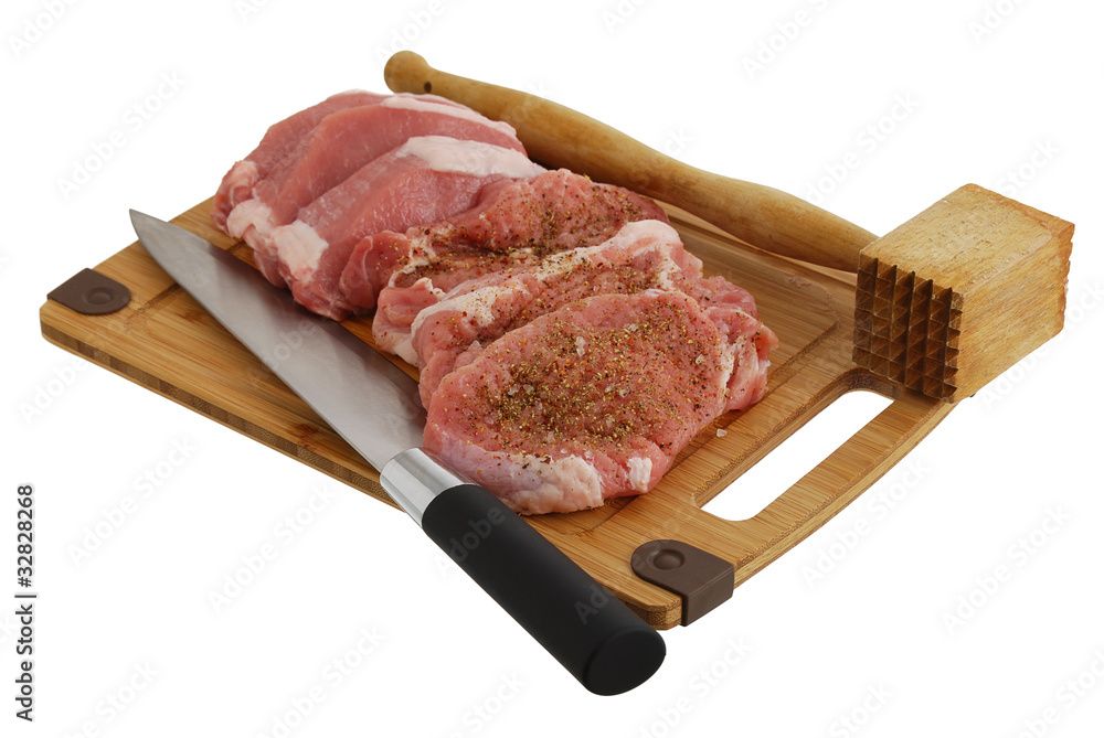 Seasoned chops with chef knife and mallet isolated on white