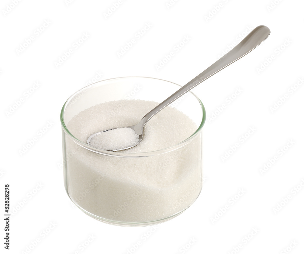 White sugar in glass bowl with teaspoon White sugar in glass bowl with teaspoon