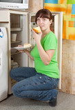 woman eating  pie from refrigerator