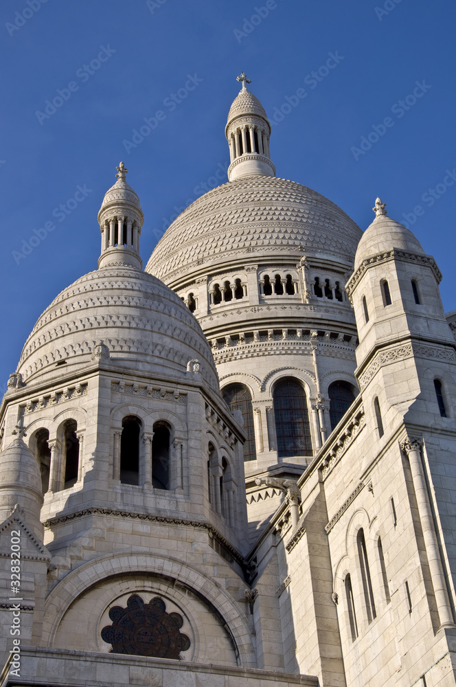 Basilica of Sacre Coeur in Paris. Against the blue sky.