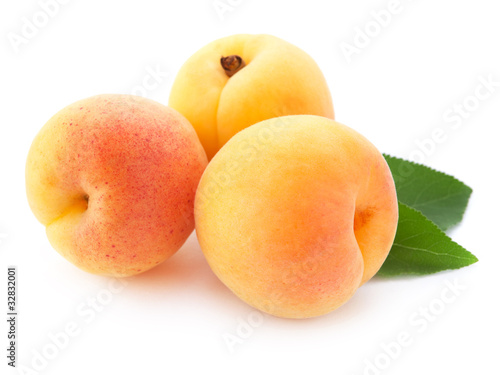 Apricot fruits with leaves isolated on white background