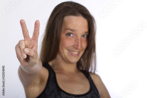 Beautiful girl showing peace with fingers