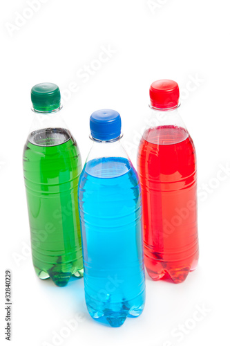 three colored plastic bottle with juice