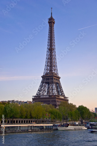 Eiffel Tower on the banks of the River Seine at sunset.