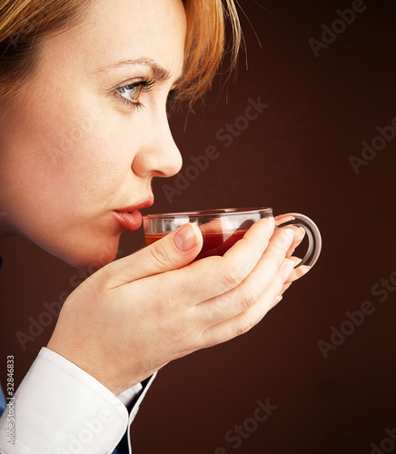 Five-o'clock tea. White collar woman relaxing with hot tea photo