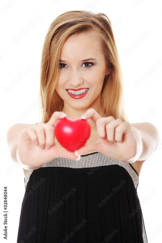 Beautiful young casual woman holding red heart Beautiful young casual woman holding red heart