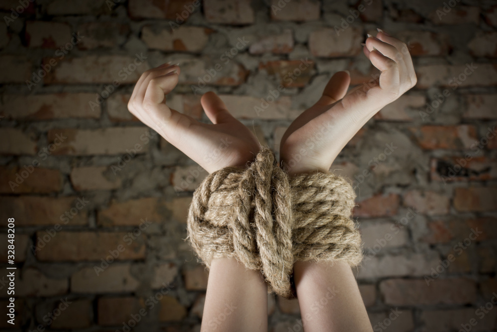 Hands tied up with rope