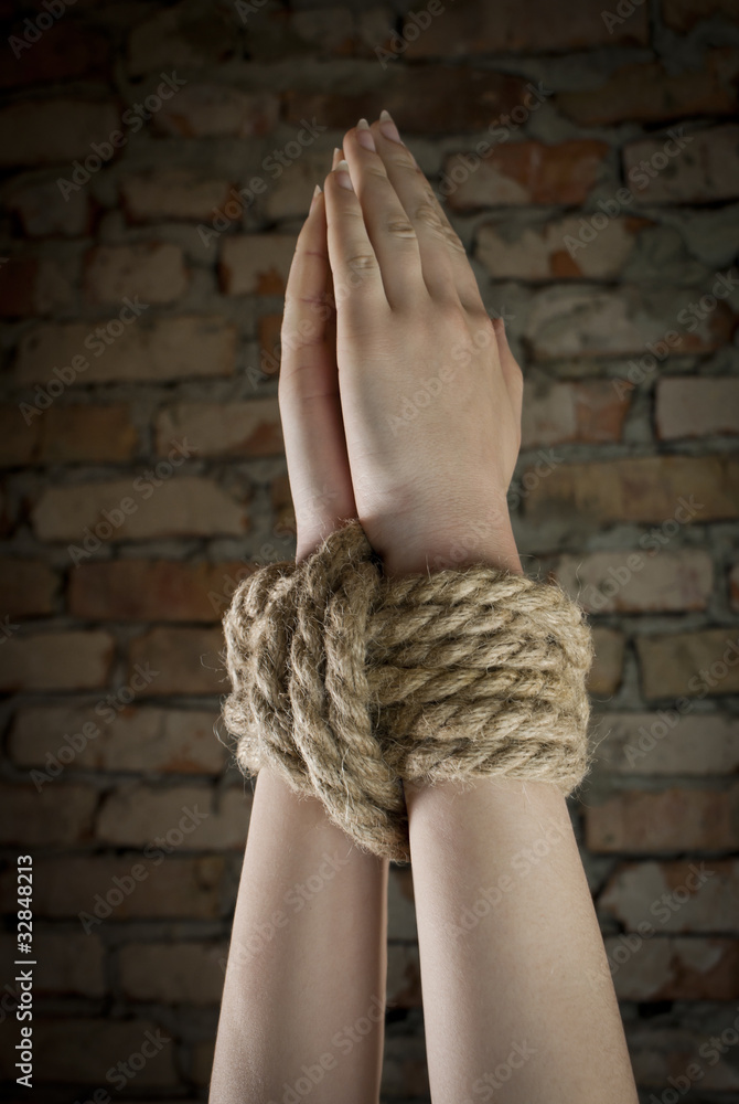 Hands tied up with rope