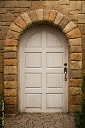 Wooden Arched Door on a Stone Wall