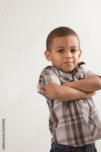 Young little boy in checkered shirt and jeans