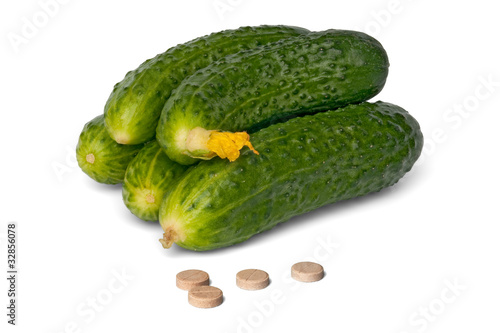 some fresh cucumbers and tablet