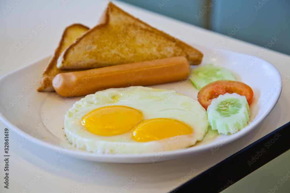 fried eggs, sausage, toast, and vegetables on white plate fried eggs, sausage, toast, and vegetables on white plate