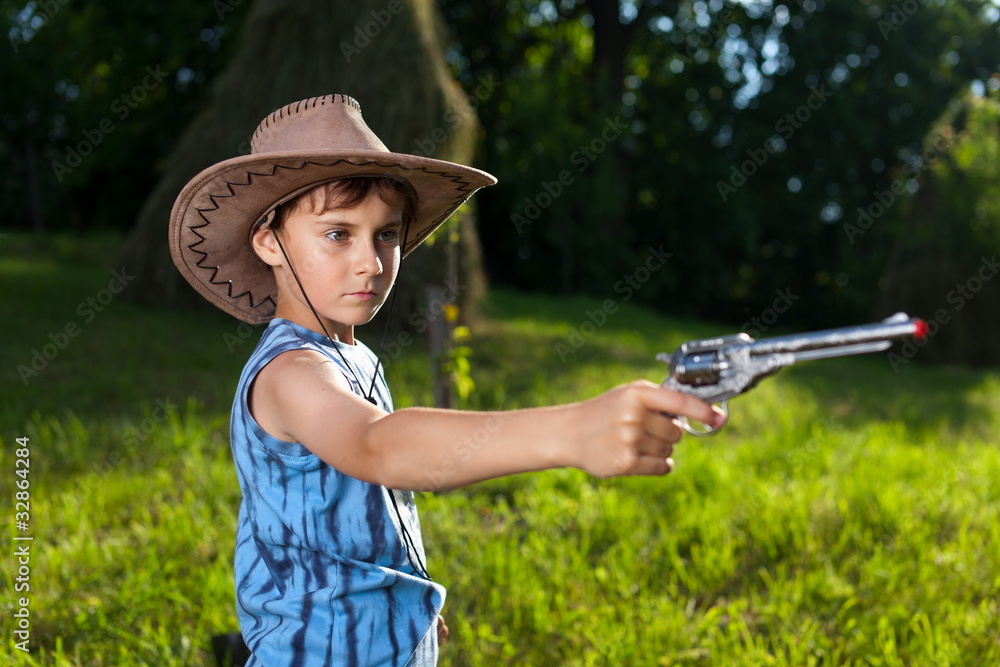 Fototapeta premium Cute kid playing cowboy