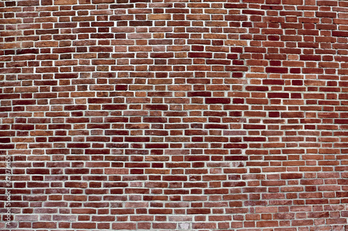 background of convex dark red brick wall