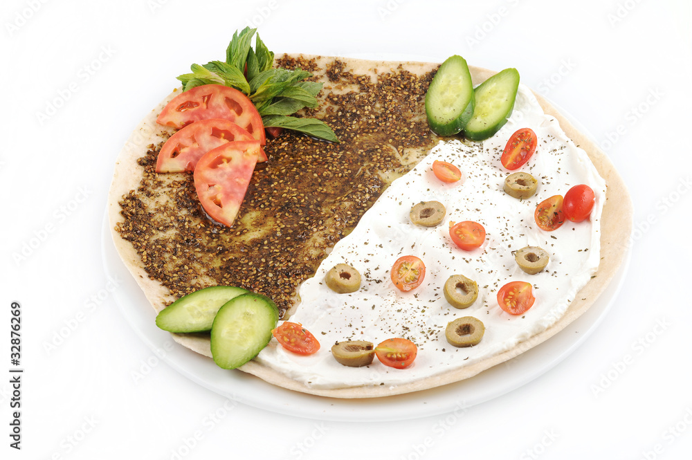 lebanese food of manakish of zaatar & labneh with veggies on top Stock