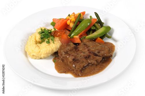 Grilled steaks, mashed potato and vegetable salad
