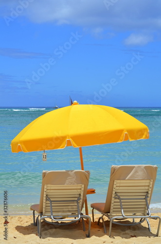Vacation Image Of Bright Yellow Beach Umbrella And Loungers